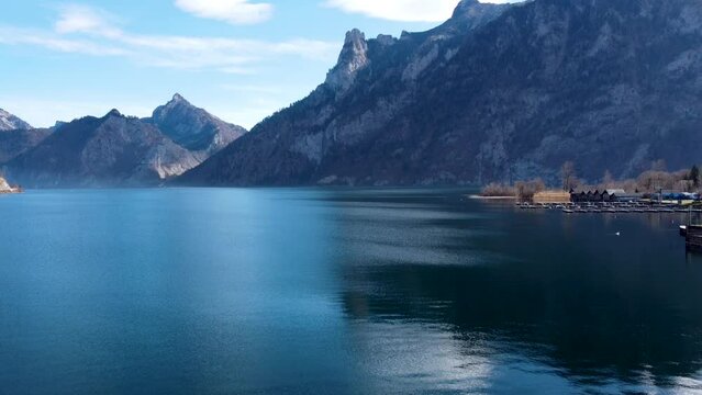 Majestic view of Traunsee lake with Traunstein mountain backdrop, sunny day, serene