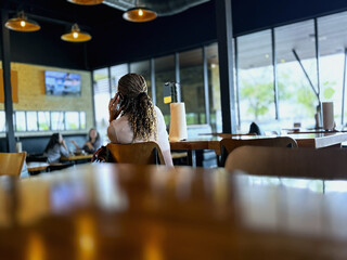 woman with a smartphone in a restaurant. background blurred.
