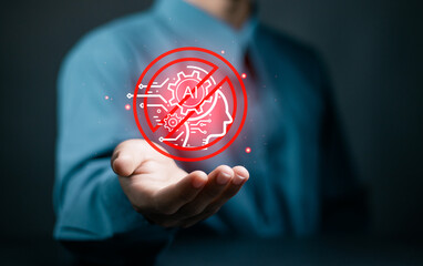 Businessman holding No AI symbol on virtual screen for Stop AI. Artificial intelligence technology.