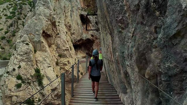 Hiker ascending steep canyon stairs at El Cabrito, slow-motion capture