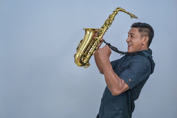 A man holding a Saxophone