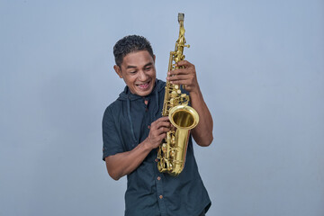 A man holding a Saxophone