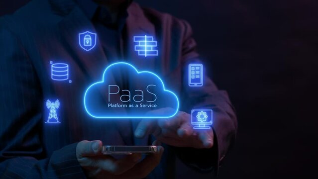 PaaS, Platform as a Service concept. Cloud computing service on software platform. Businessman working with smartphone to operate cloud PaaS icon on virtual screen.