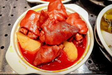 Pork leg stewed in red chilli sauce
