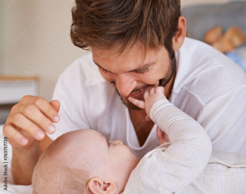 Sticker Happy, love and baby with father on bed relaxing, playing and bonding together at home. Smile, sweet and young dad laying with girl child, infant or kid in bedroom or nursery at family house.