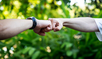 Deal of teamwork with the Man hand a fist bump commit as get together in the office