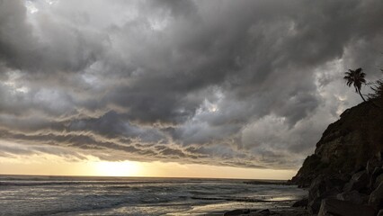A stormy day sunset - Southern California beach scenes with sunsets, surfers, tide pools and palms trees at Swamis Reef Surf Park Encinitas California. - obrazy, fototapety, plakaty