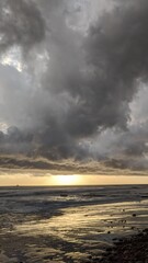 Naklejka na ściany i meble A stormy day sunset - Southern California beach scenes with sunsets, surfers, tide pools and palms trees at Swamis Reef Surf Park Encinitas California.