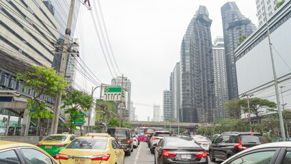 1 January 2024 in Bangkok, Thailand Image of cars parked at a red light in a long procession on a...