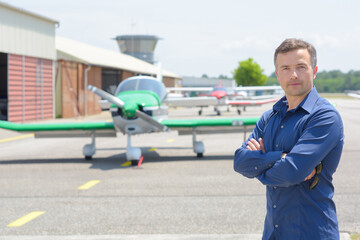 man with an airplane in the background