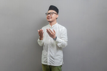 Asian Muslim man standing looking empty space happily to show grateful