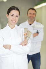 female painter apprentice is looking at the camera