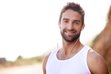 Fitness, headphones and portrait of man in nature for exercise, workout and music for training. Male person, earphones and mockup with smile for streaming, audio or podcast for outdoor morning cardio