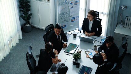 Top view of smart executive manager looking at financial graph while skilled business team shake...