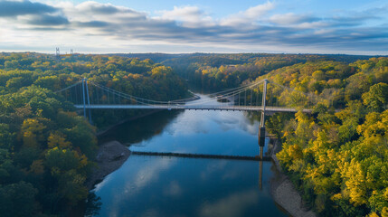 A captivating aerial view of a modern suspension bridge spanning across a river photography