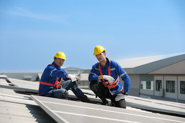 Engineers install solae cell on the roof of factory