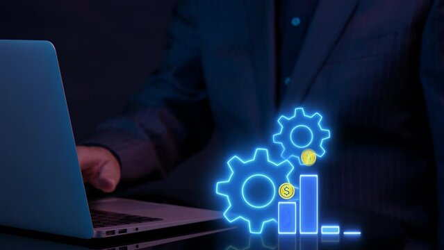 Money, profit, cashflow, investment, economy, finance and success concept. Businessman working computer to show glowing neon line animation of dollar sign graph and chart with gears spinning around.