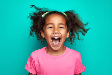 Joyful Young Girl Laughing with Hair Blowing Against a Vibrant Teal Background, Studio Portrait of Childlike Happiness and Energetic Expression