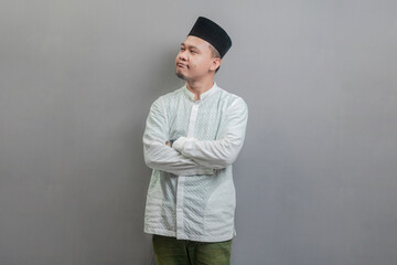 Asian Muslim man standing with crossed arm