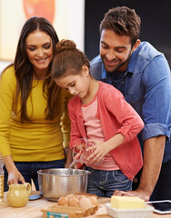 Parents, girl and kitchen for baking with love, ingredients for cake or dessert with support and handmade with care. Mom, dad and kid together in family home for bonding or teaching with affection.