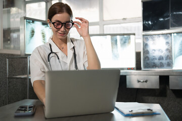 Female doctor checking anatomy and physiology x-ray film of patient in the hospital. Doctor...