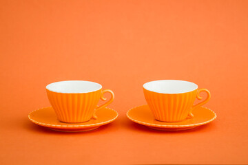 Array of Orange Coffee Cups Against Vibrant Orange Background, Generative AI
