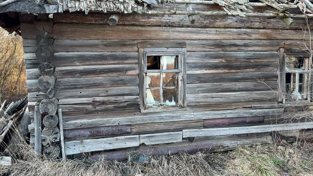 Abandoned house in village. Old wooden house in countryside in spring. No people in village. Old House in rural. Abandoned village with destroyed houses. Wooden Home ruin in countryside