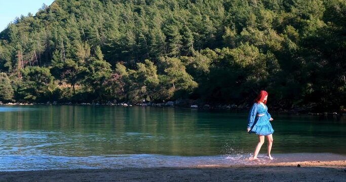 In a mysterious sea within the forest, a young girl, clad in a graceful dress, dances with the rhythm of the water, inspiring  as she revels in perfect harmony