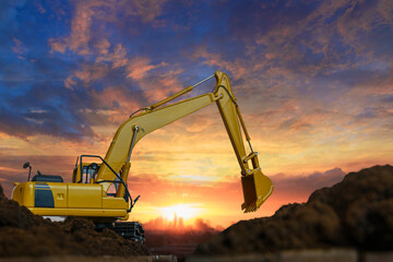 Crawler excavator with Bucket lift up are digging the soil in the construction site on the sunset sky backgrounds