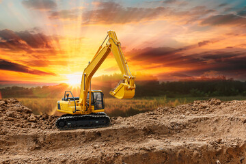 Crawler excavator with are digging the soil in the construction site on the sunset backgrounds