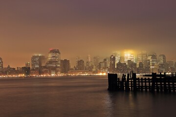Fototapeta na wymiar Manhattan midtown skyscrapers and New York City skyline at night with fog