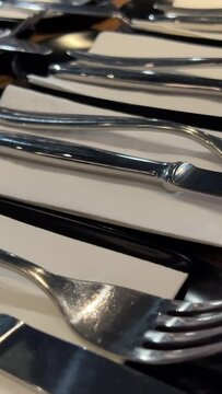 Rotating knife and fork that glitter against black background. High quality 4k footage