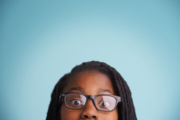 Vision, glasses or black kid with wow eyes in studio for eyecare, wellness or optometry on blue...