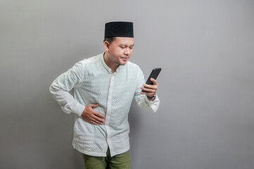 Asian Muslim man holding back hunger and waiting for the time to break the fast