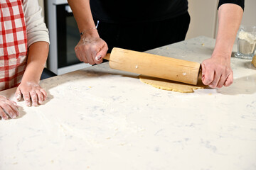 Mother and daughter kneading dough