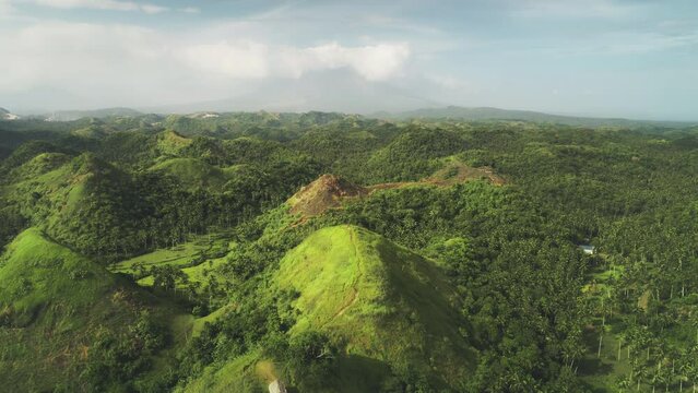 Aerial Philippines hill landscape: nobody wild nature with green tropic forest, abudant plant, high grass, lush mosses. Beautiful asian landmark natural wonder cinematic shooting in 4K, UHD shot