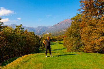 Happy Golfer on Golf Course Menaggio with Mountain View in Autumn in Lombardy, Italy.