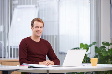 Portrait, smile and business man on laptop at desk in office for creative career in startup...