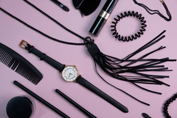  background of different fashionable women's accessories,things,watches,makeup brushes necklace,bracelet or jewelry on a pink background close-up top view