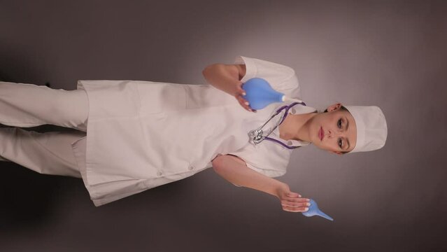Emotional young woman doctor nurse in a white coat and hat