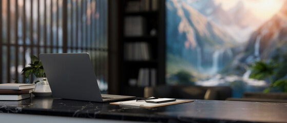 A back view image of a laptop and report on a black marble desk in a contemporary private office.