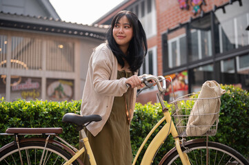 Naklejka premium A woman going to a supermarket with her bicycle. A female traveller exploring the city with a bike.