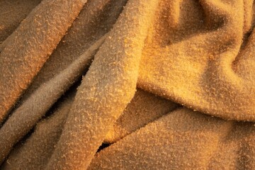A piece of fabric with a brown color and a fuzzy texture