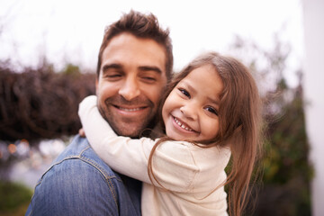 Fototapeta premium Hug, love and father carry girl for bonding, outside and family for quality time. Portrait, parent and young daughter with smile in nature, embrace and happiness for vacation or travel with dad