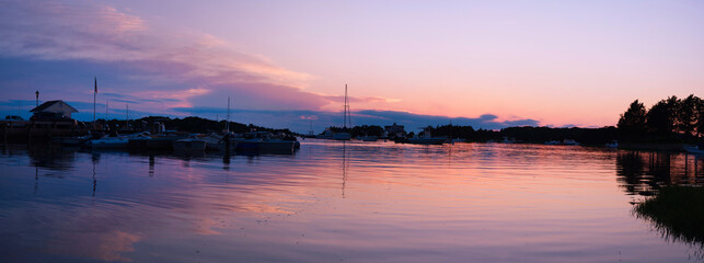 Cape Cod Sunrise Seascape Panorama at Quissett Harbor in Falmouth, Massachusetts, USA, a tranquil twilight coastal beauty with moored boats under warm pink dawn break - obrazy, fototapety, plakaty
