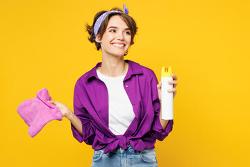 Young woman wears purple shirt casual clothes do housework tidy up hold in hand air freshener...