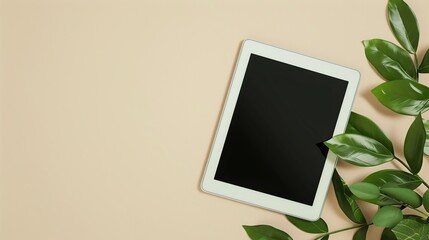 beige background with leaves and ipad