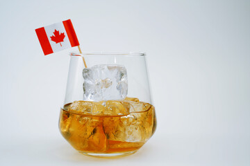 Cocktail drink on the rocks with canadian flag isolated at white
