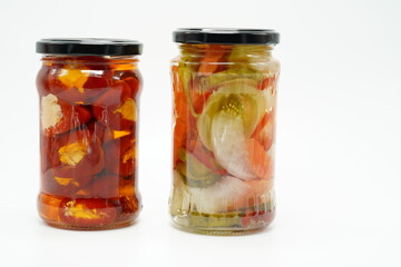 Pickles peppers tomatoes carrots chili homemade food in vase isolated at white