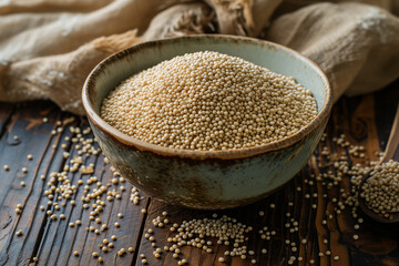 amaranth groat raw in bowl on wooden countertop, selective focus